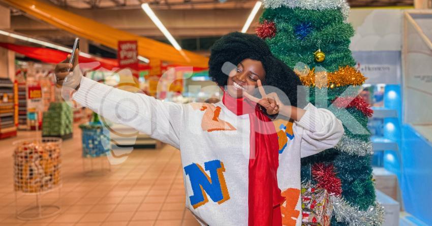Girl taking a selfie in front of a christmas tree