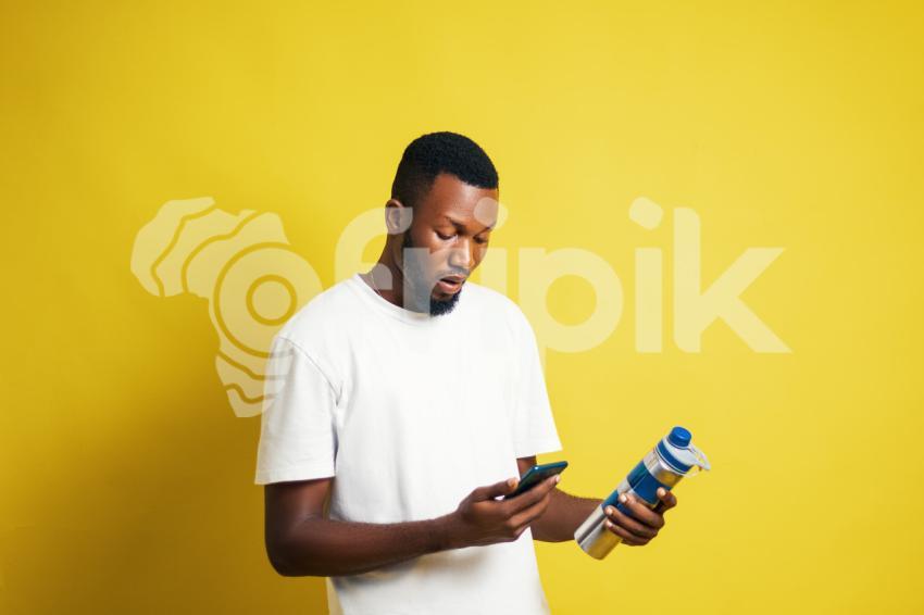 Man with bottle pressing his phone