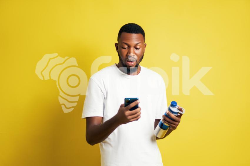 Man with water bottle pressing phone