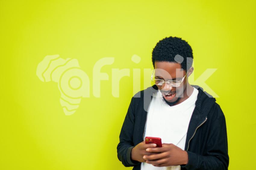 Boy pressing his phone happily