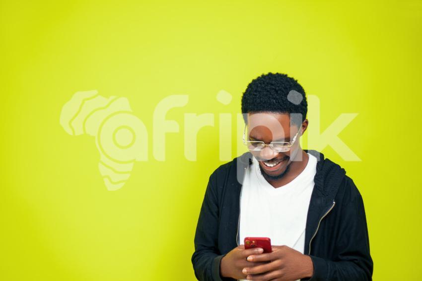 Boy pressing phone happily