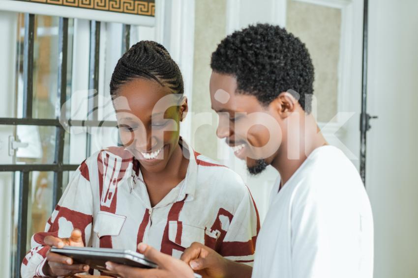 Boy and girl pressing a laptop