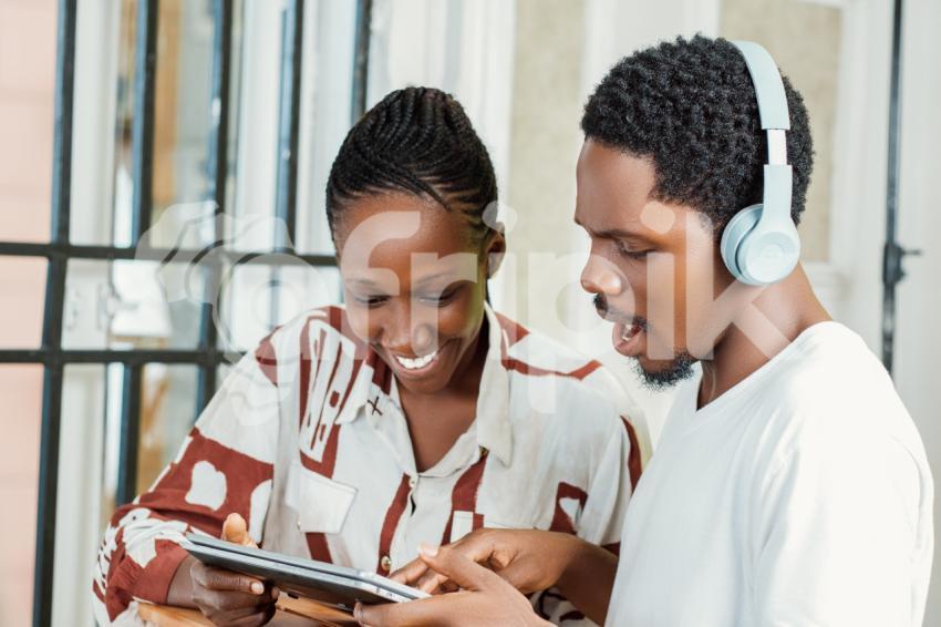 Girl and boy looking at a laptop