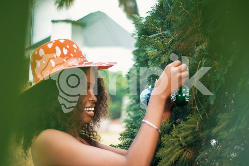 Girl decorating a christmas tree