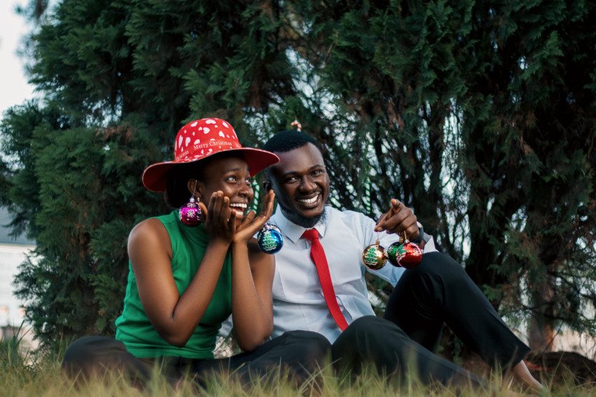 Happy girl and boy sitting on the grass