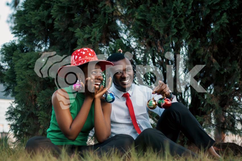 Happy girl and boy sitting on the grass