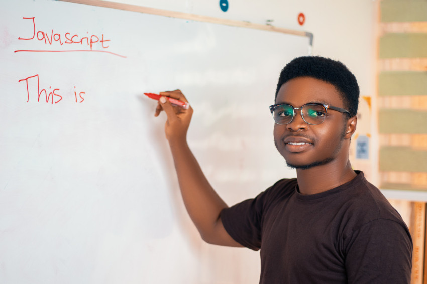 Male teacher writing on a whiteboard