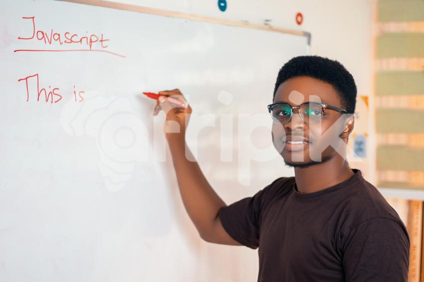Male teacher writing on a whiteboard