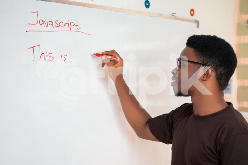 Male teacher writing on a whiteboard 1