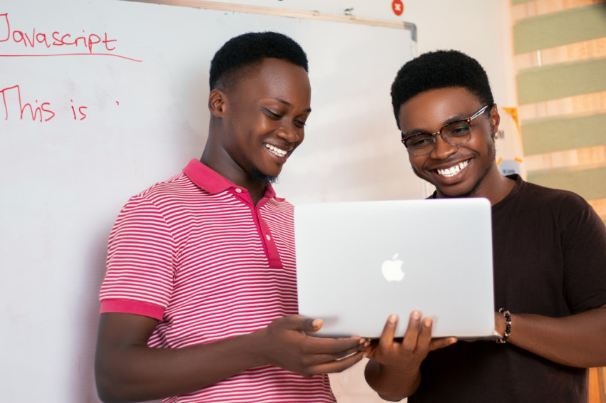 2 men with a laptop