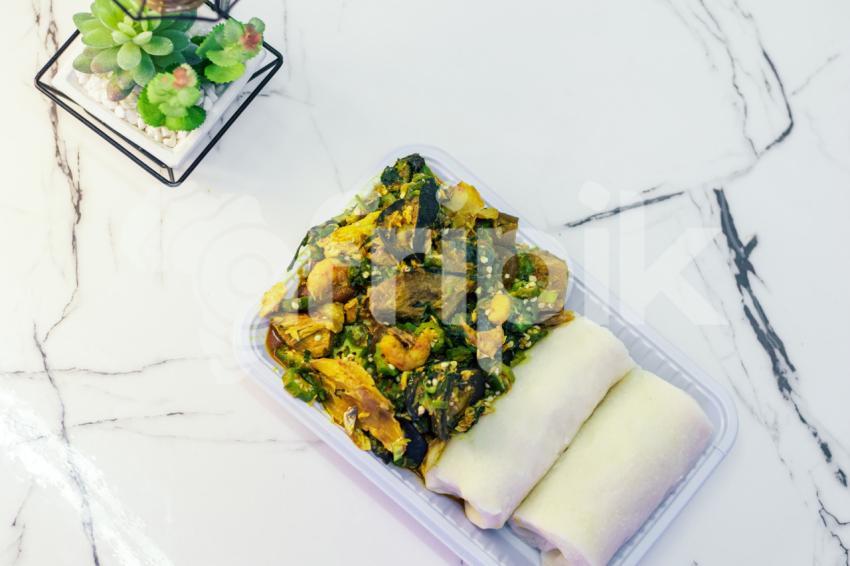 A plate of seafood okro with fufu