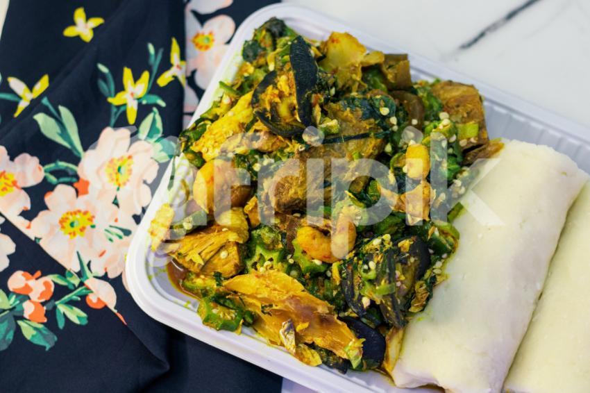 A plate of seafood okro with fufu 1
