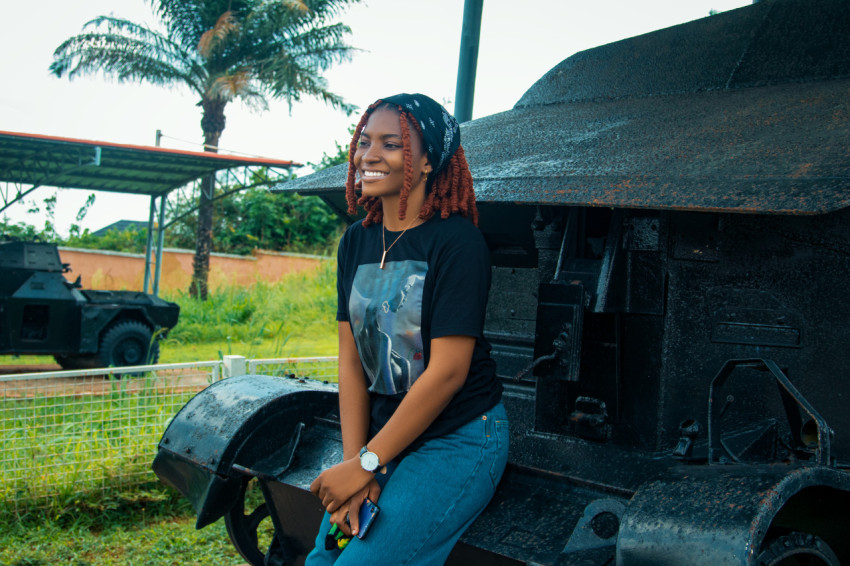 Girl sitting on an armoured tank