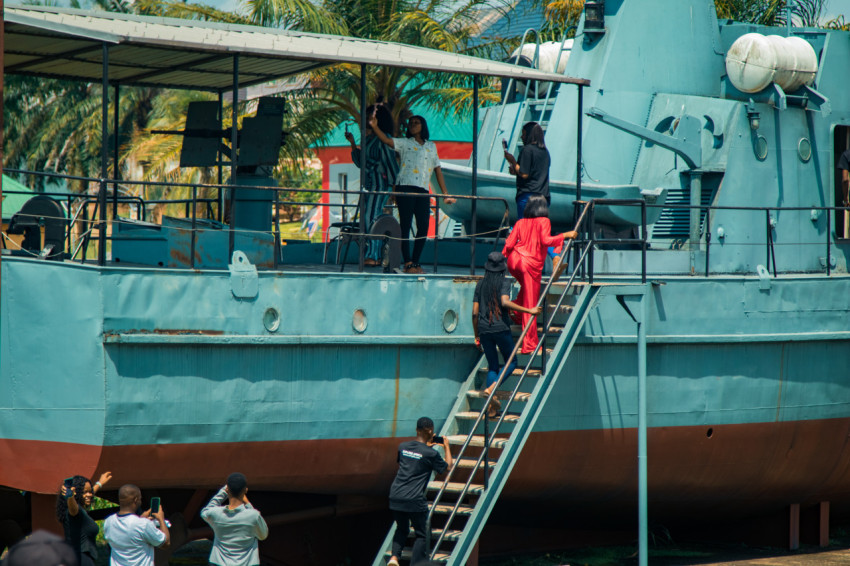 A group of tourist entering a war ship