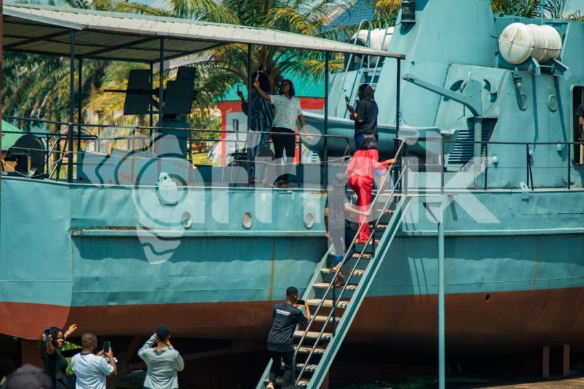 A group of tourist entering a war ship