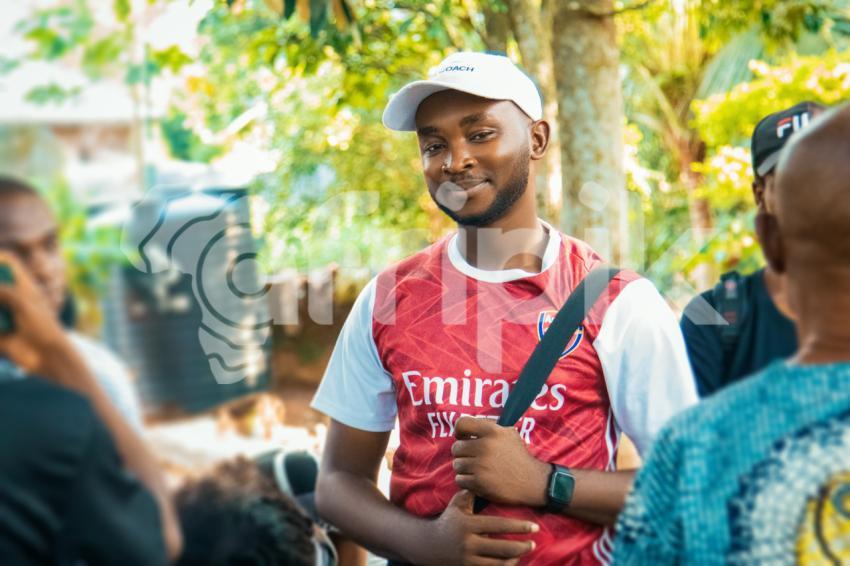 Man on arsenal jersey smiling