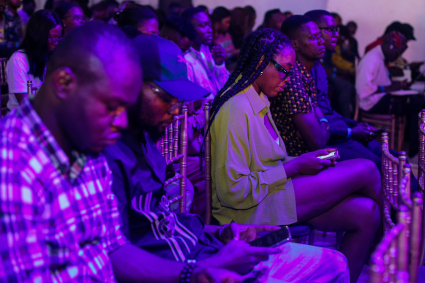 Attendees pressing their phones at UDC 2024