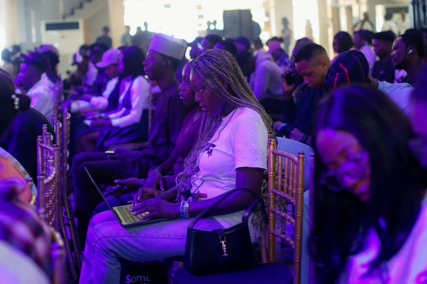 Attendee pressing her laptop in a conference