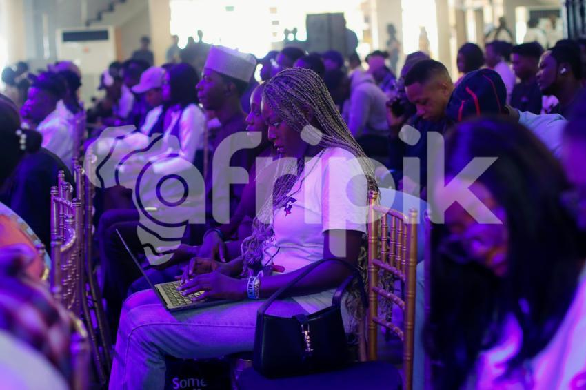 Attendee pressing her laptop in a conference