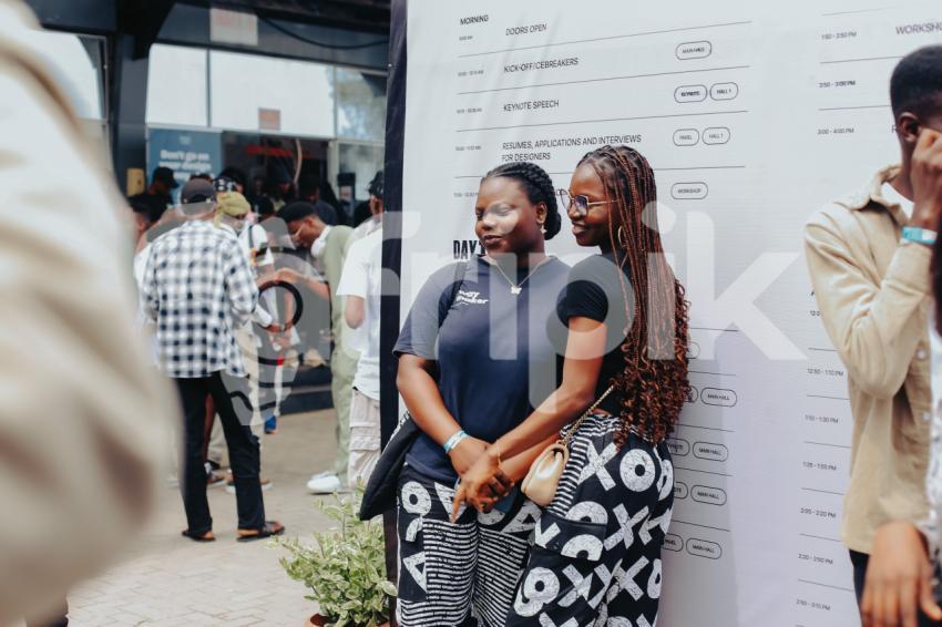 Two friends taking pictures at UDC 2024