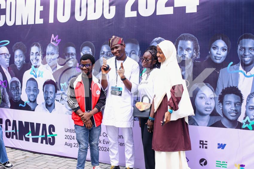 Attendees taking pictures at UDC 2024