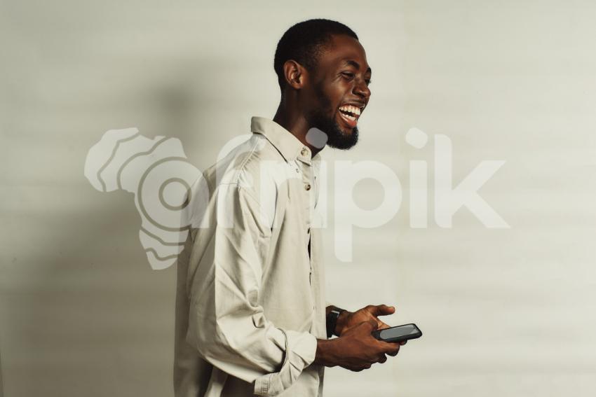 Boy with phone smiling