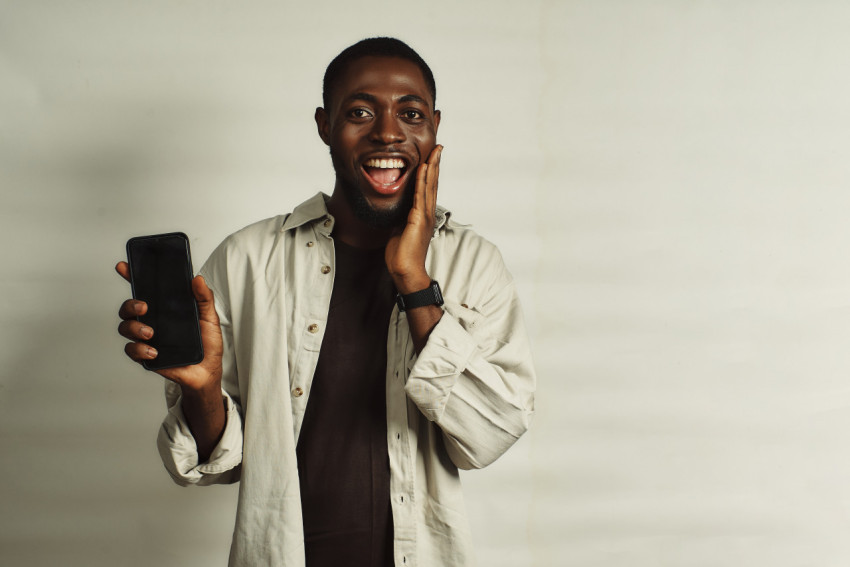 Boy with phone smiling 1