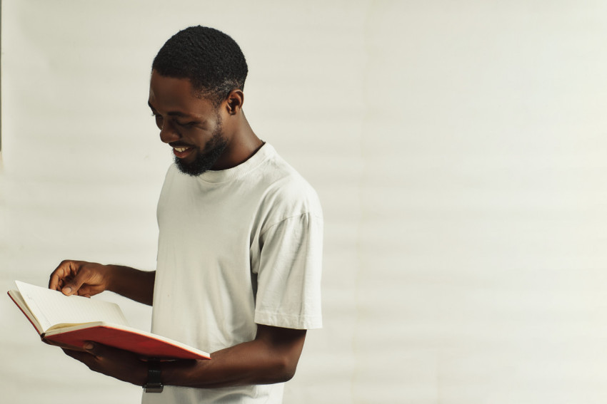 Happy boy reading a book