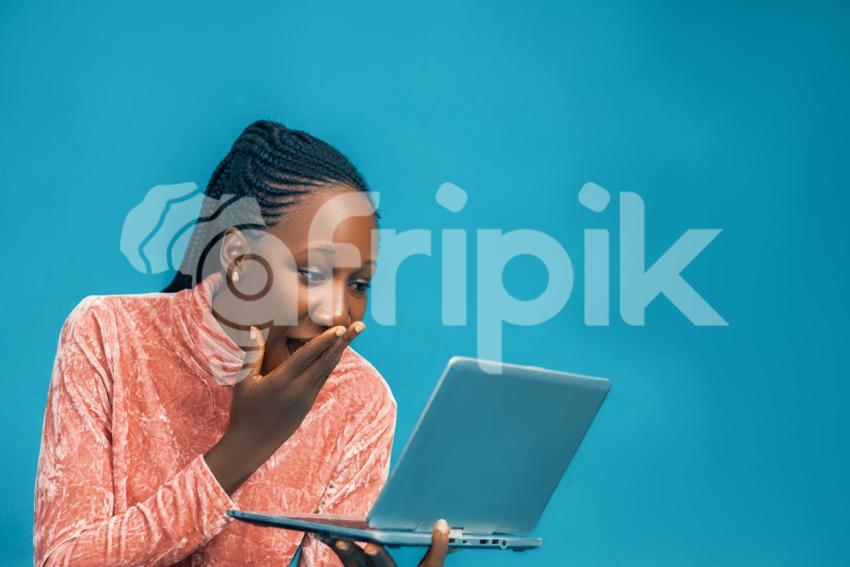 Girl looking at her laptop surprised