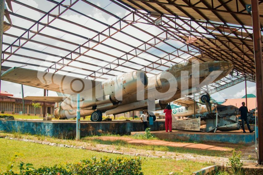 People standing beneath a war plane