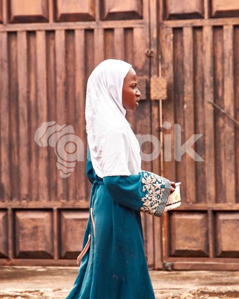 Girl wearing hijab holding a plate