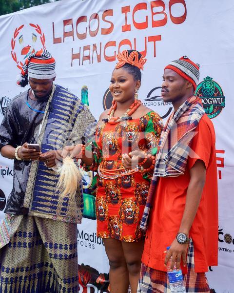 People posing in traditional outfits