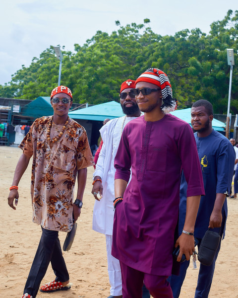 Boys walking wearing traditional outfits