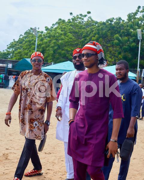Boys walking wearing traditional outfits