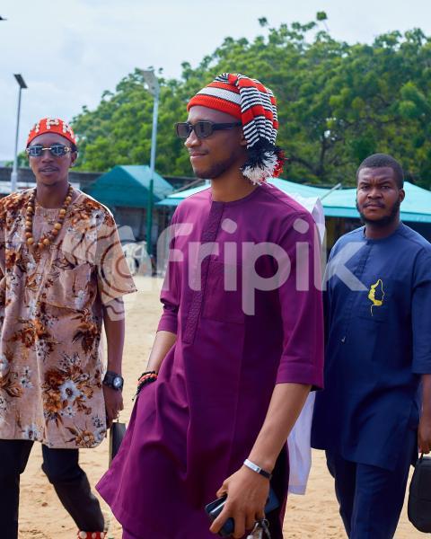 Boys walking wearing traditional outfits 1