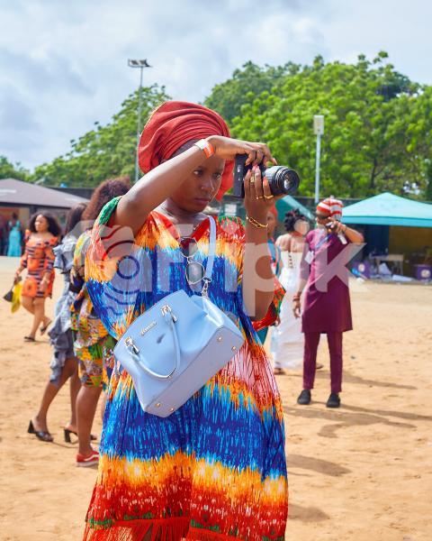 A camera girl wearing Ankara dress