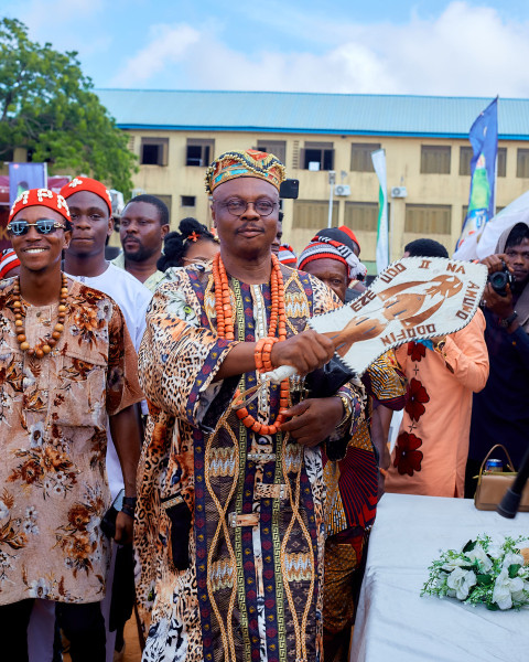 A traditional ruler cheering his people