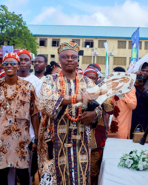 A traditional ruler cheering his people