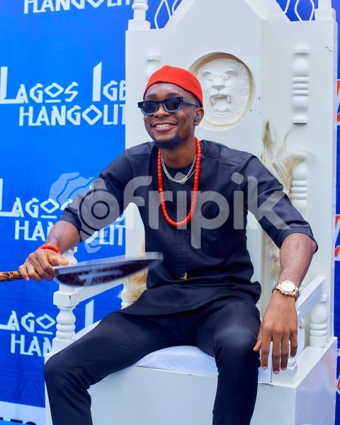 Boy sitting on a chair wearing cultural attire