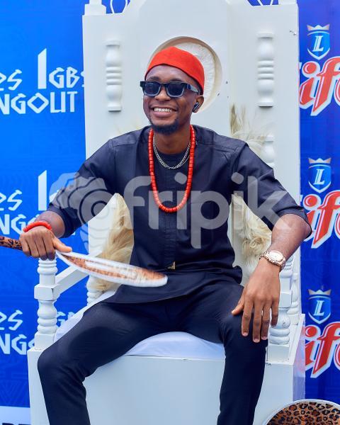 Boy sitting on a chair wearing cultural attire 1