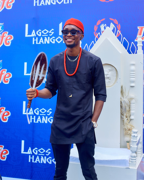 A boy wearing a traditional outfit standing