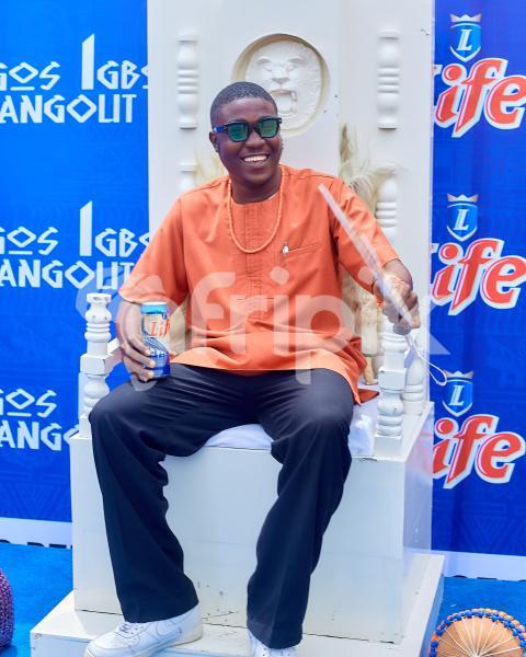 Boy sitting on a chair wearing cultural attire 3