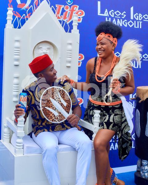 A girl standing beside a boy sitting 1