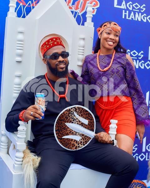A girl standing beside a boy sitting 2