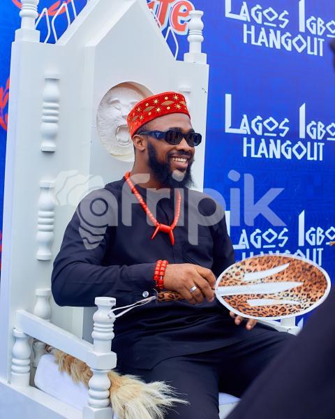 A boy smiling while sitting on a chair 1