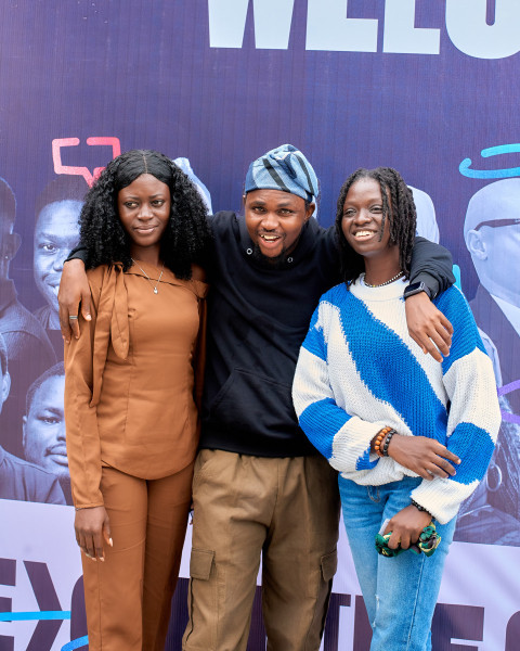 A guy posing with two ladies at UDC 2024