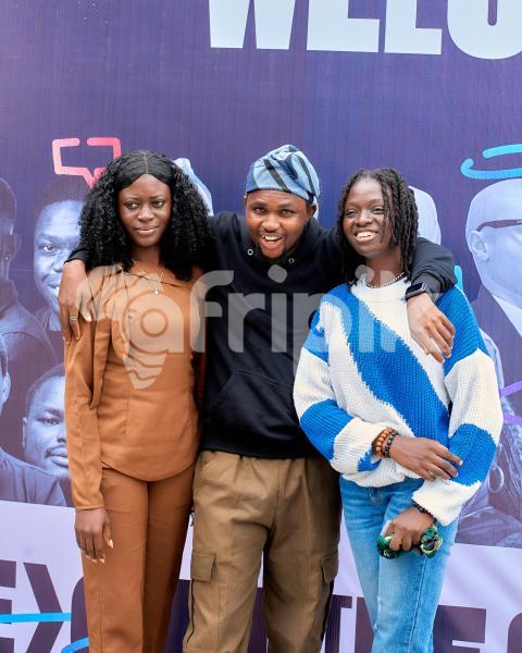 A guy posing with two ladies at UDC 2024
