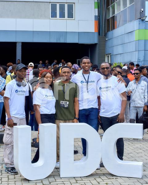 Some gentlemen and lady taking a photo