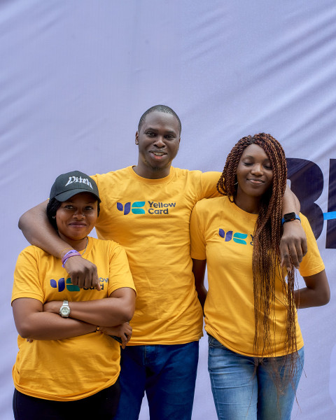 A boy posing with two ladies