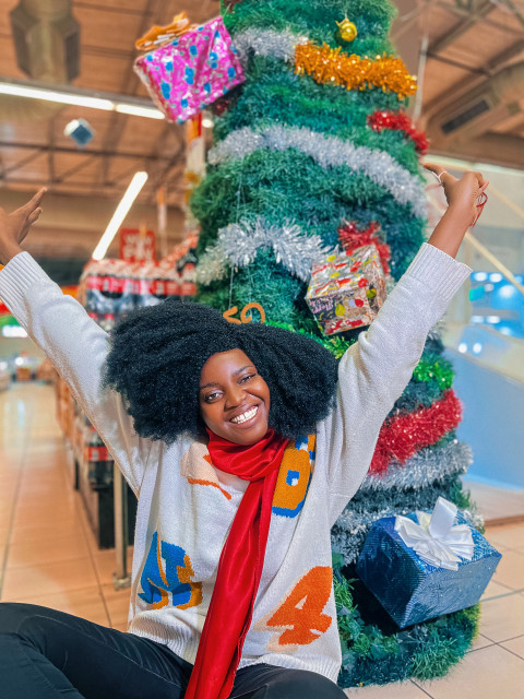 Happy girl in front of a christmas tree